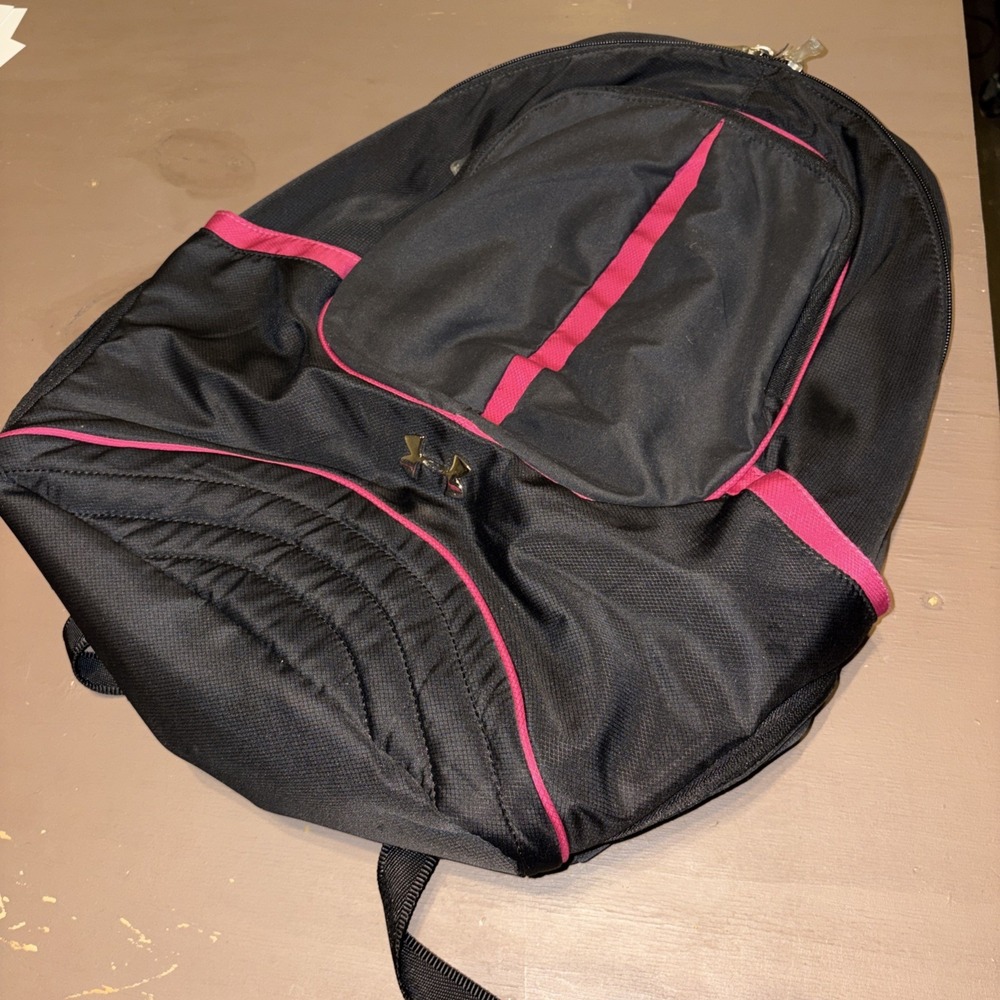 Women's black Under Armour backpack featuring distinct pink trim metallic logo